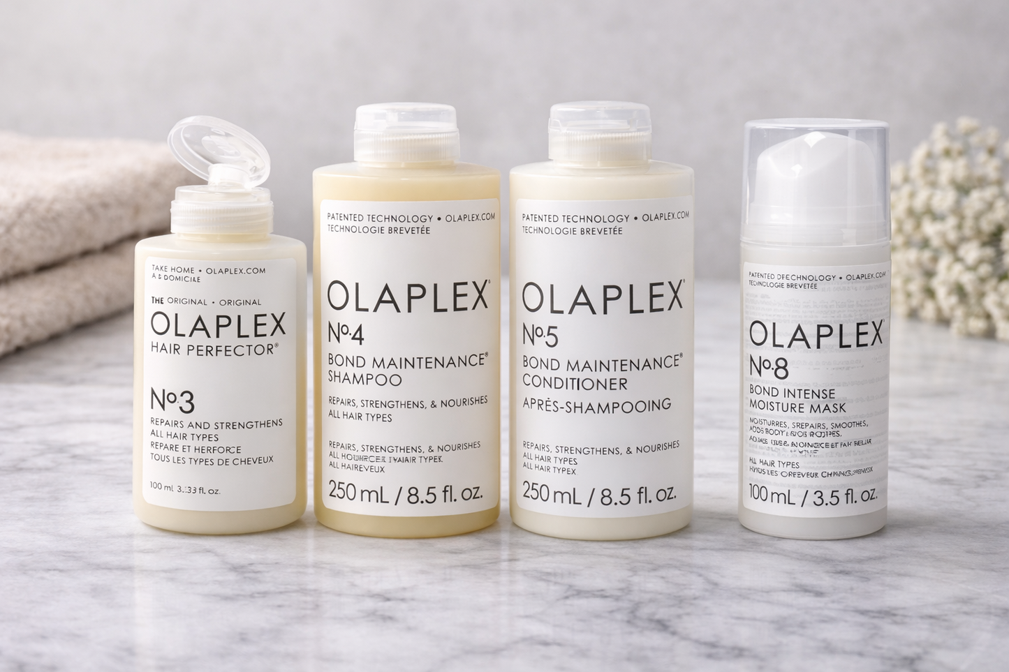 Olaplex Pflegeroutine, vier Produkte No.3 No.4 No.5 und No.8 nebeneinander auf hellem Untergrund – Olaplex