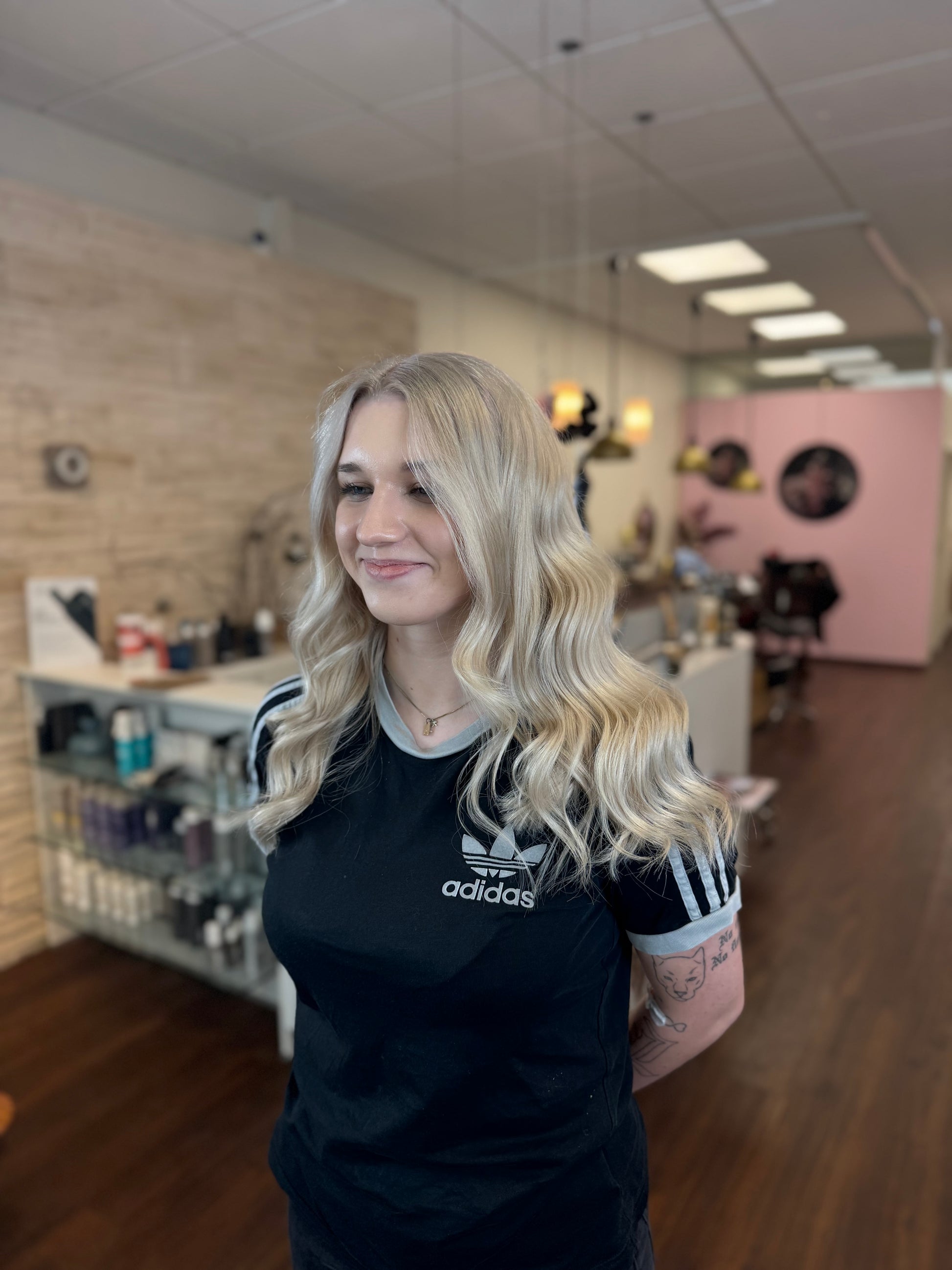Blondiertes Haar mit weichen Wellen und gesundem Glanz im Friseursalon, Ergebnis nach Pflegebehandlung – Paul Mitchell