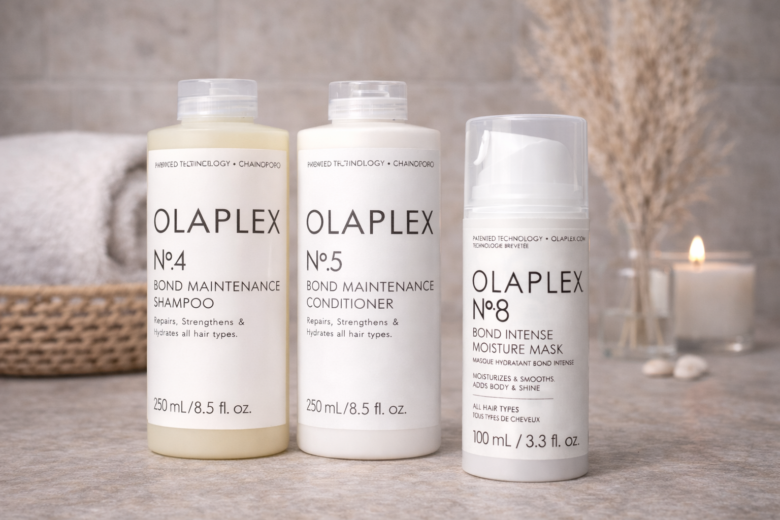 Olaplex Pflegeset Bond Maintenance Shampoo Conditioner und Maske, drei Produkte nebeneinander auf ruhigem Spa-Hintergrund – Olaplex