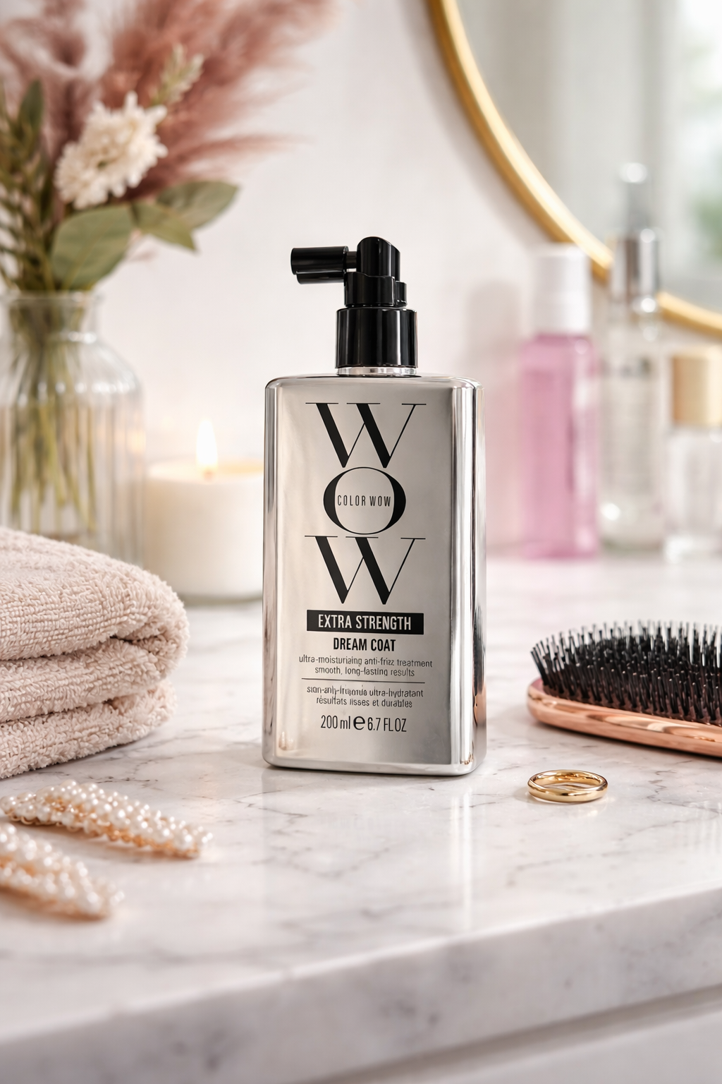 Color Wow Dream Coat Extra Strength Spray stehend auf heller Ablage im Badezimmer mit Pflegeaccessoires – Color Wow